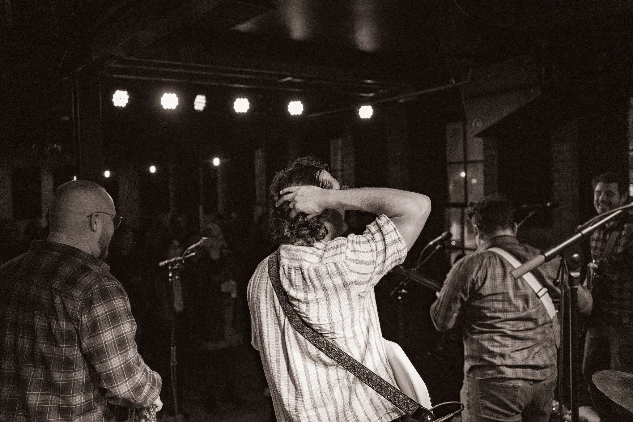 a black and white photo of a group of people in a room