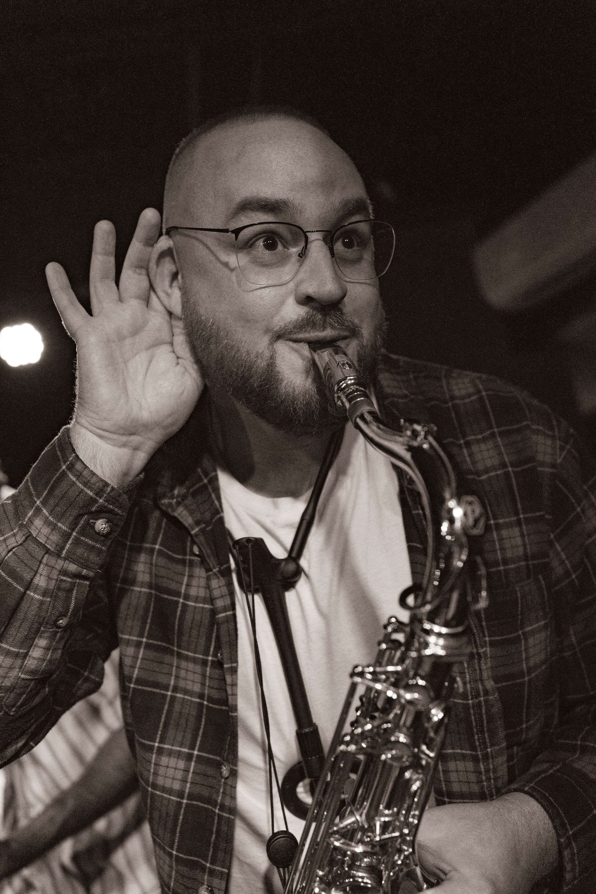 a man holding a saxophone
