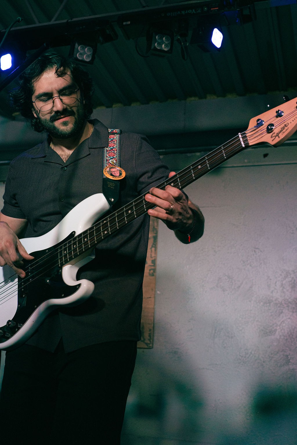 a man playing a bass guitar at a concert