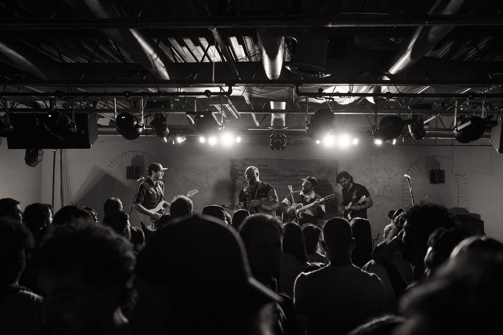 a black and white photo of a crowd at a concert