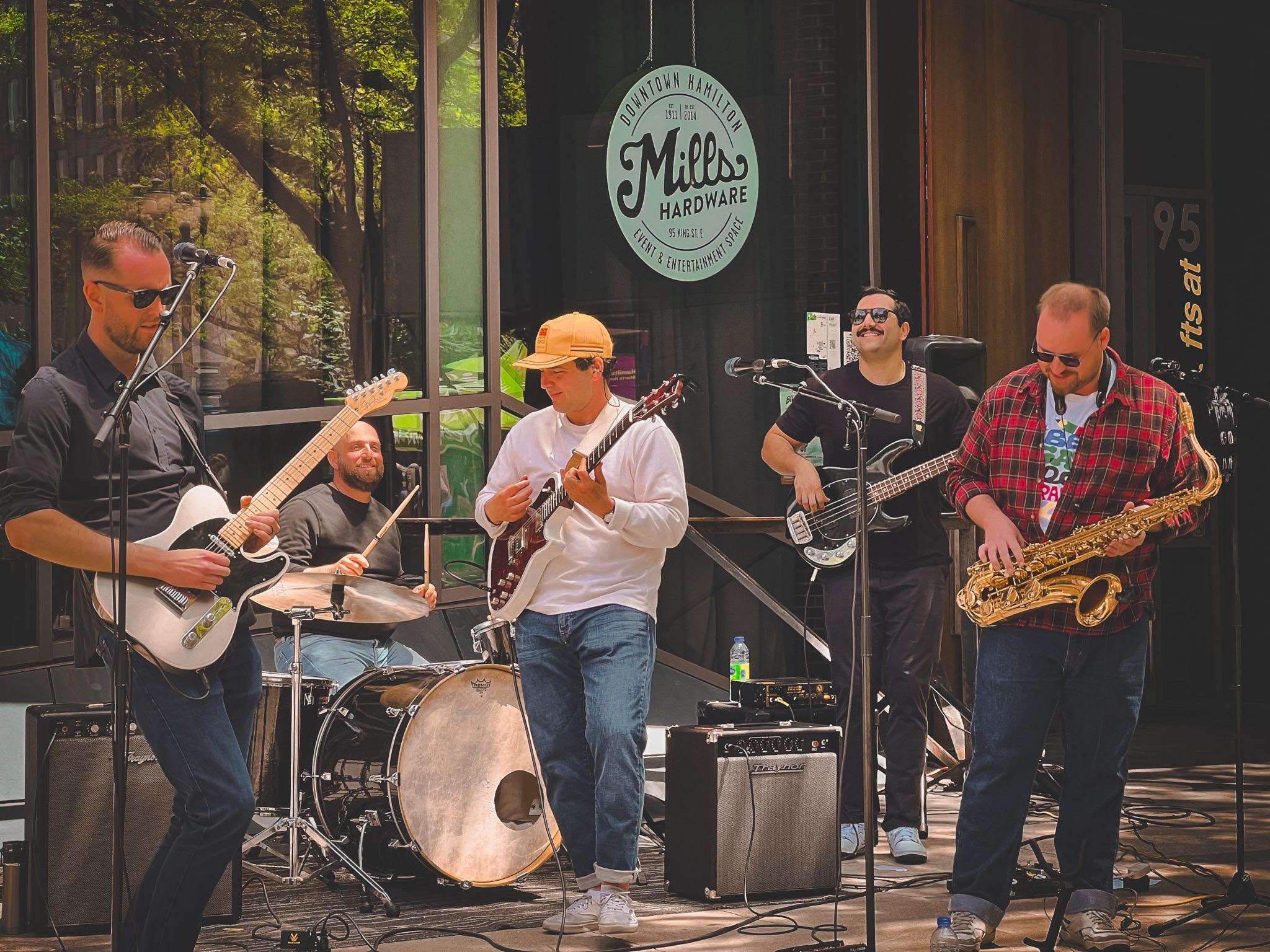 a group of people playing music in front of a building
